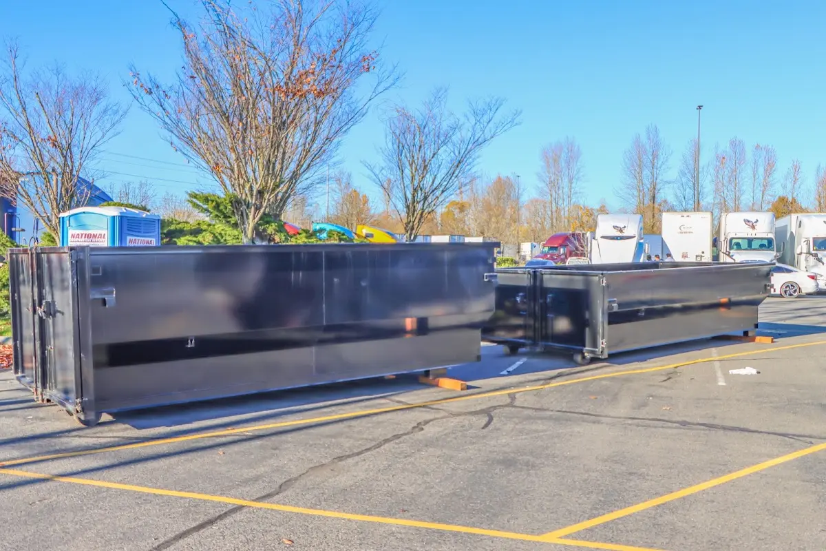 Professional dumpster rental service with roll-off container on residential driveway in McPherson